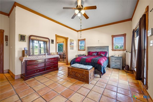a bedroom with furniture and a chandelier