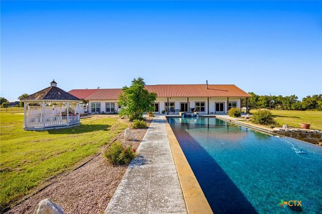 a view of swimming pool with outdoor seating and yard