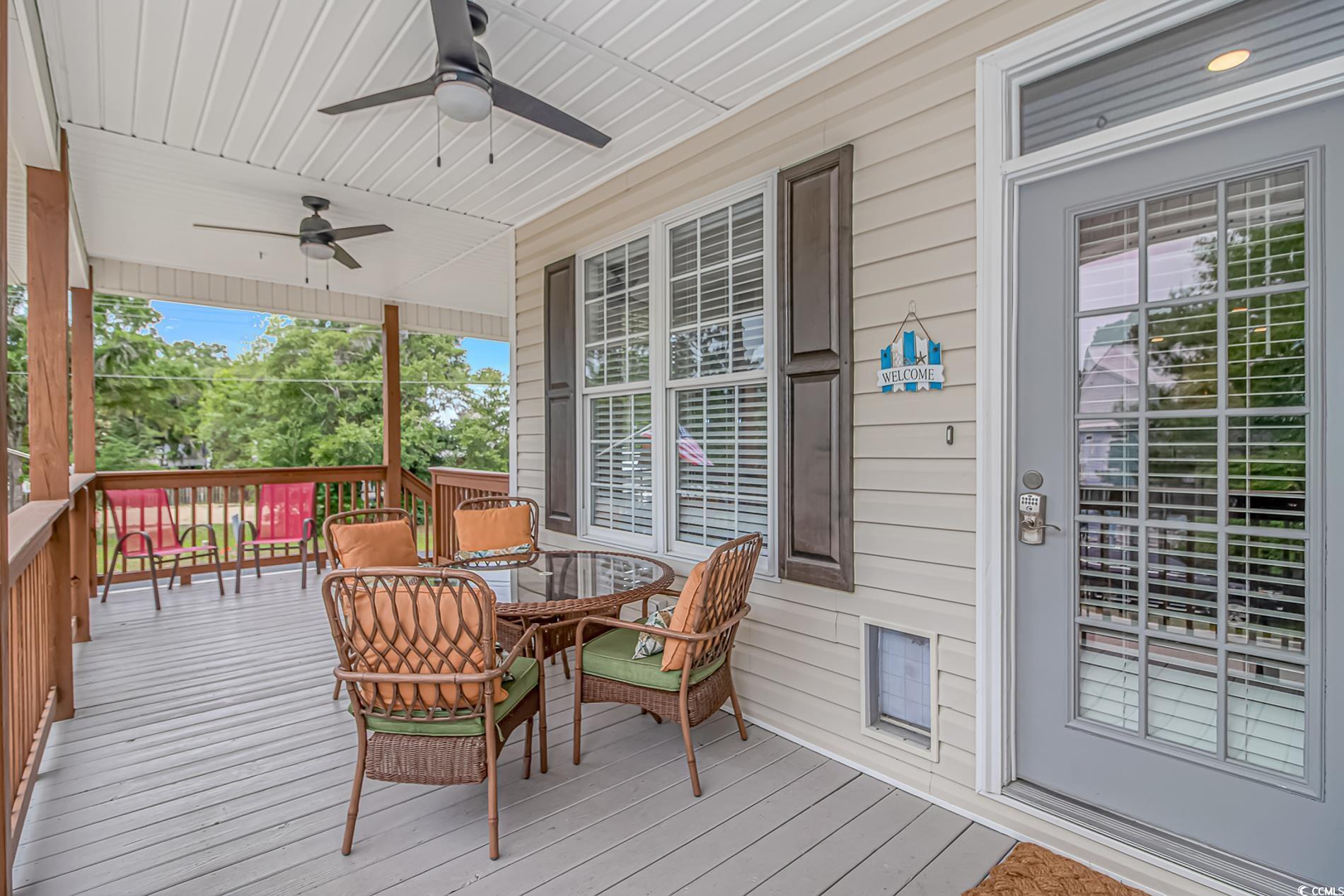4600 Murrells Inlet Road Murrells Inlet, SC 29576 - Photo 3 of 40 Wooden terrace with ceiling fan and outdoor dining