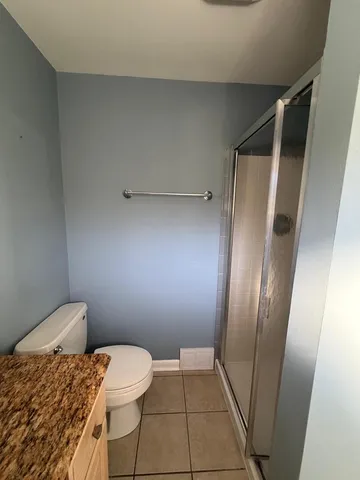 a bathroom with a toilet and a shower