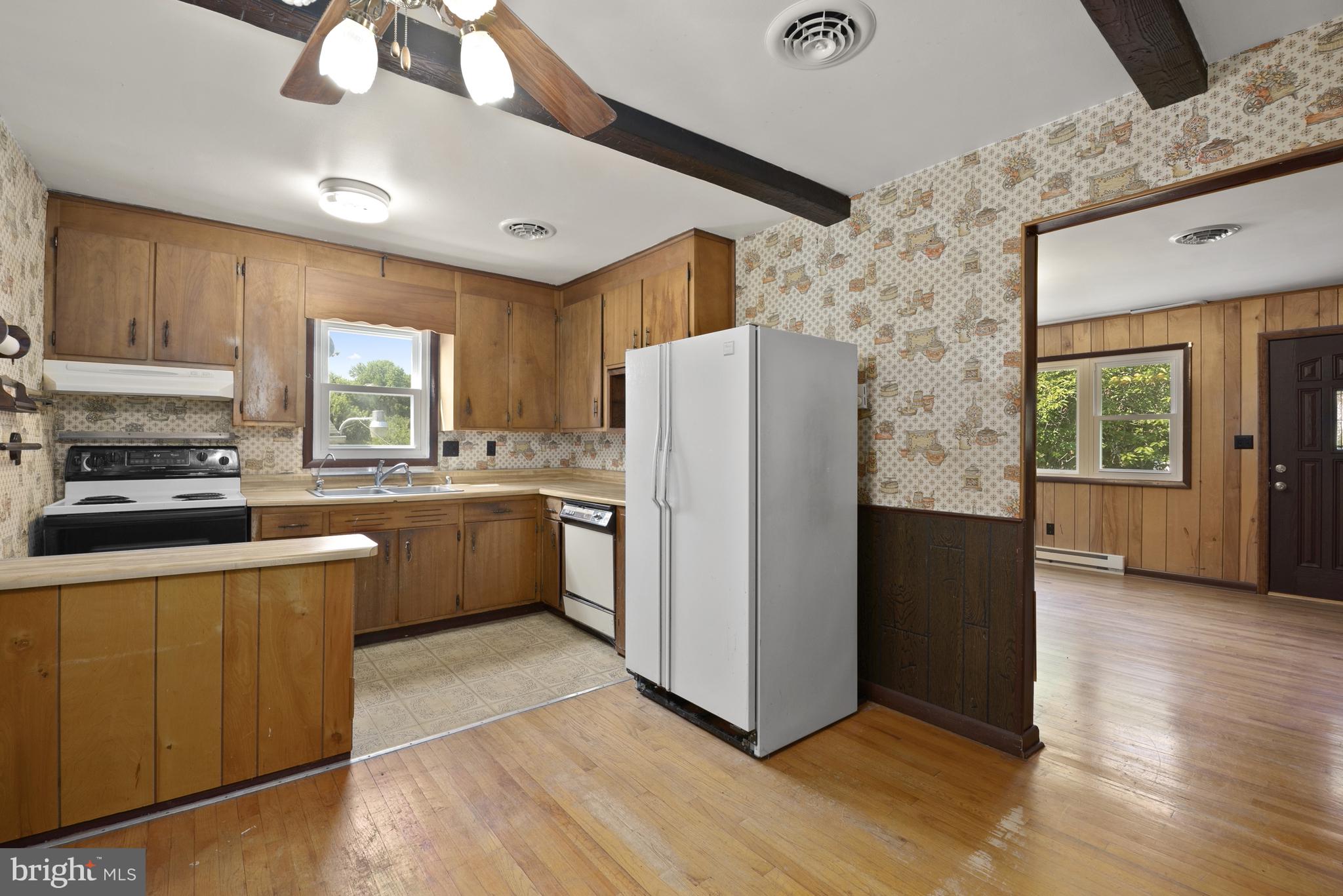 380 Harrisville Road Colora, MD 21917 - Photo 7 of 22 a kitchen with a refrigerator a stove top oven a sink and dishwasher with wooden floor