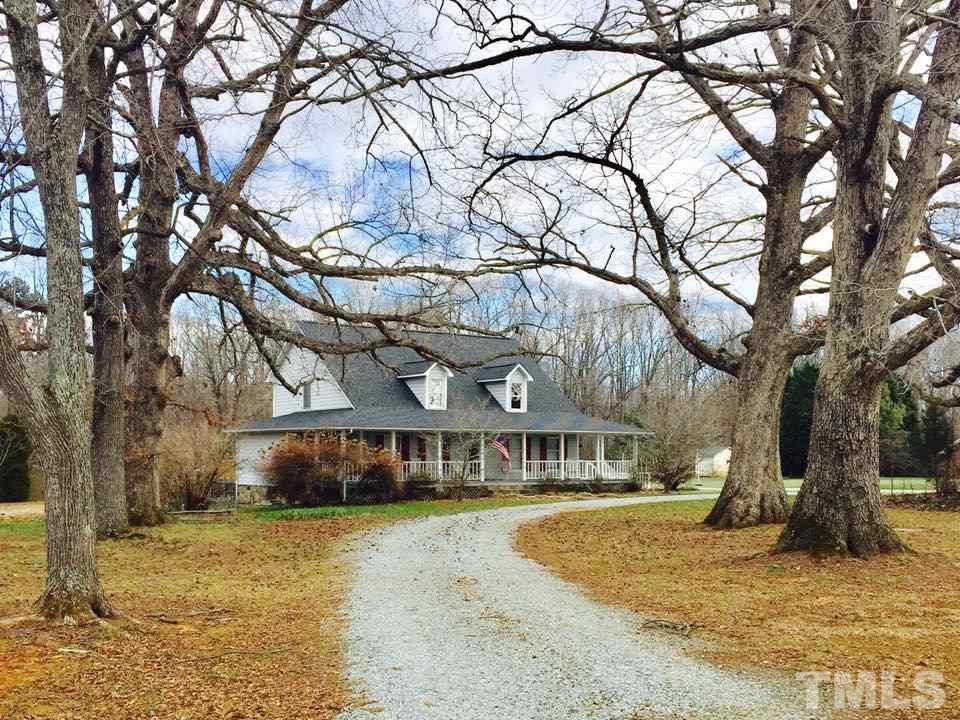 529 Noah Davis Road Roxboro, NC 27574 - Photo 1 of 25 a view of a large house with a large tree