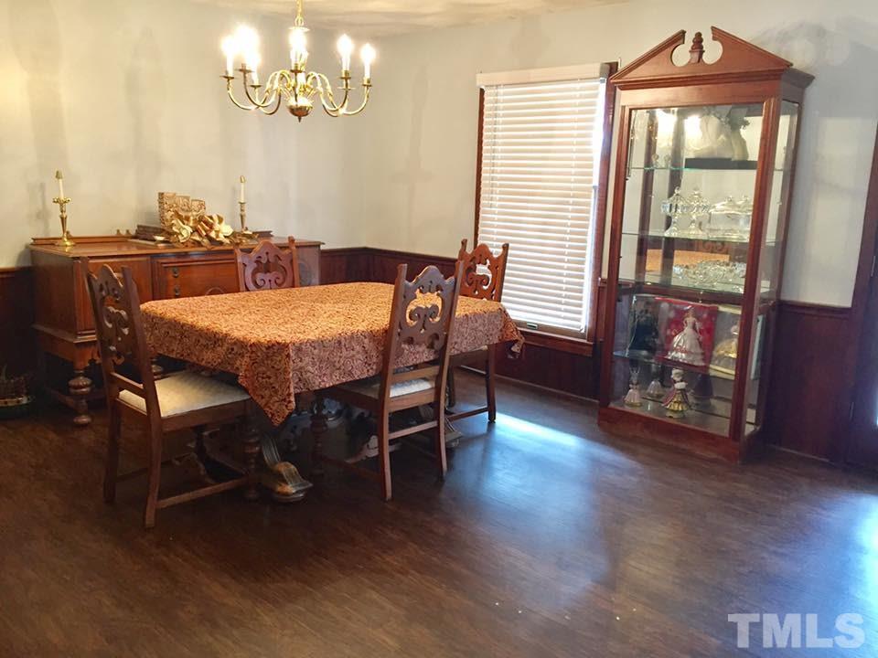 529 Noah Davis Road Roxboro, NC 27574 - Photo 13 of 25 a dining room with furniture and wooden floor