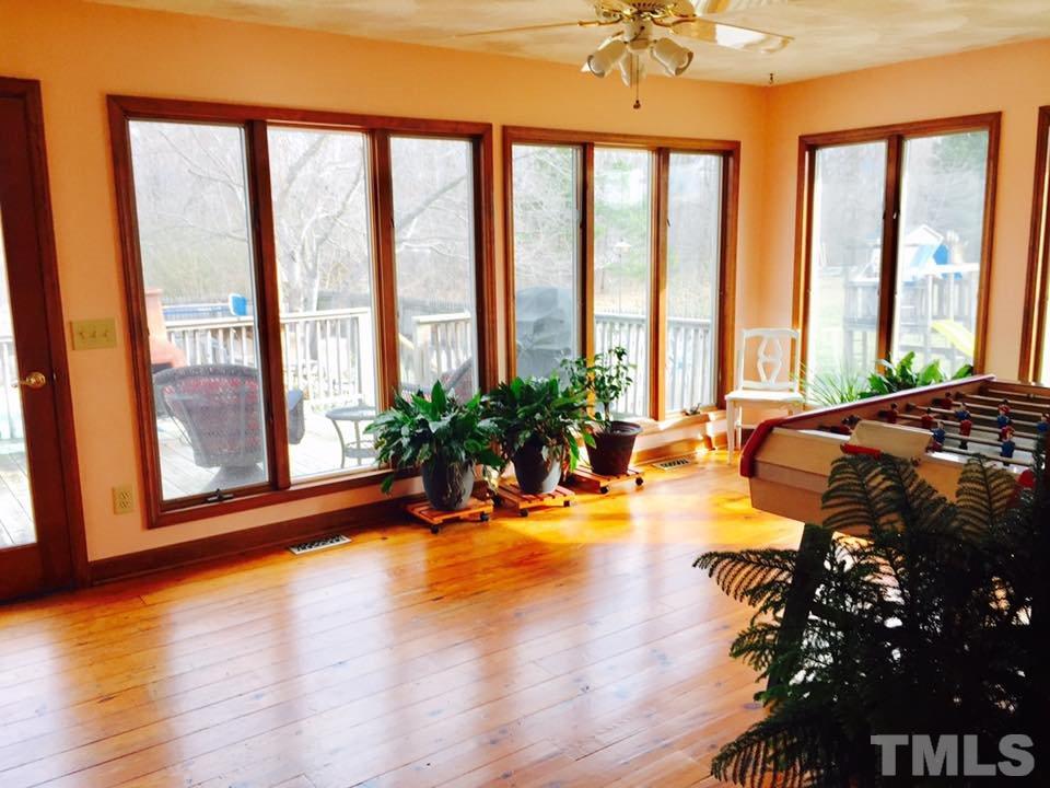 529 Noah Davis Road Roxboro, NC 27574 - Photo 14 of 25 a view of a spacious bedroom with a bed and wooden floor