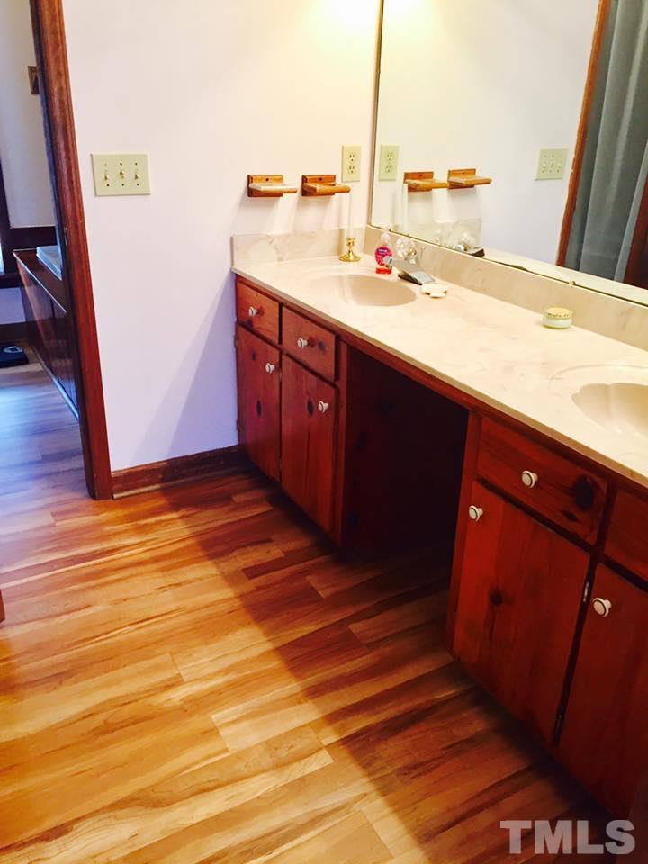 529 Noah Davis Road Roxboro, NC 27574 - Photo 16 of 25 a bathroom with a sink and a mirror