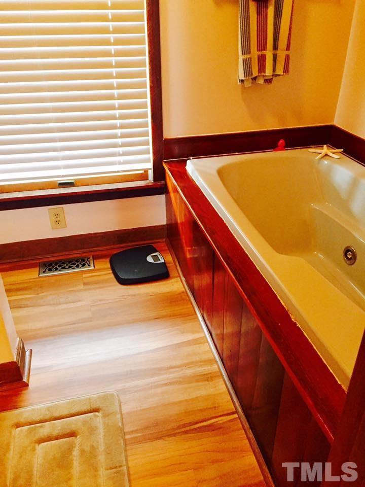 529 Noah Davis Road Roxboro, NC 27574 - Photo 17 of 25 a bathroom with a tub and a window