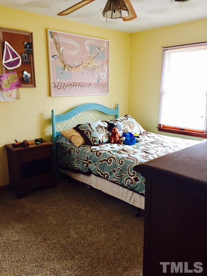 529 Noah Davis Road Roxboro, NC 27574 - Photo 19 of 25 a bed sitting in a bedroom next to a window