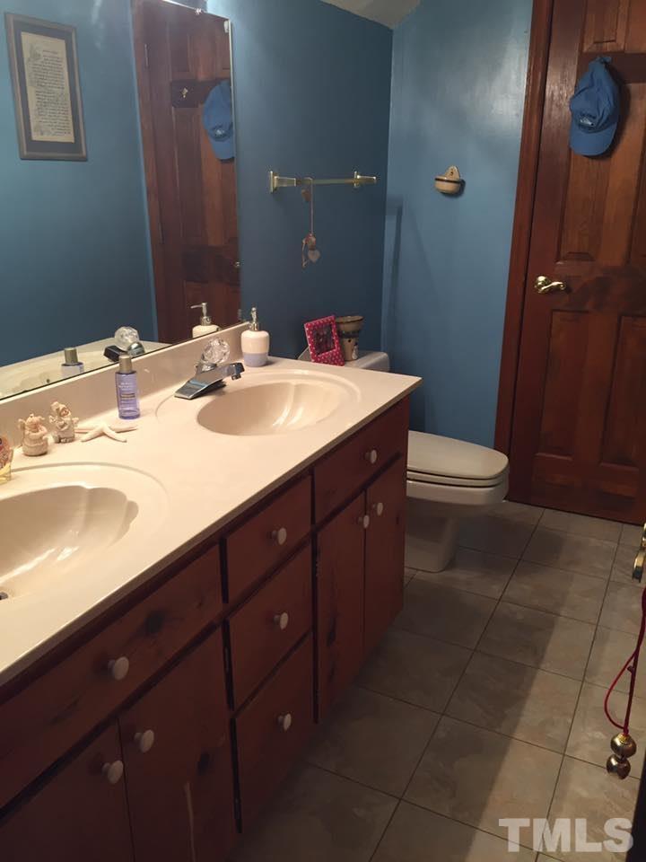 529 Noah Davis Road Roxboro, NC 27574 - Photo 20 of 25 a bathroom with a sink vanity and a mirror