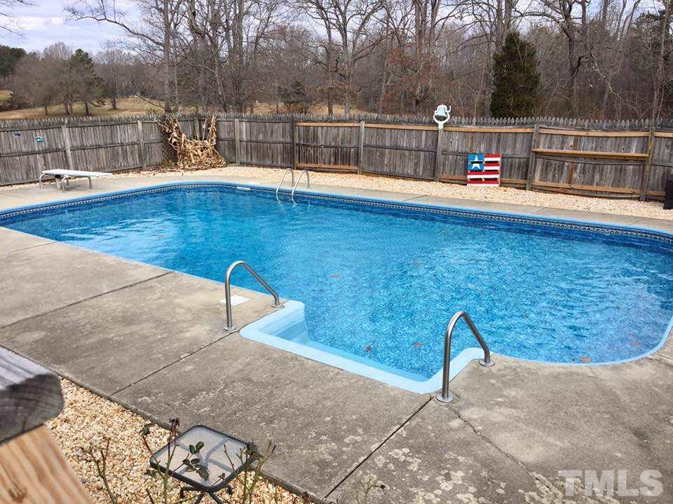 529 Noah Davis Road Roxboro, NC 27574 - Photo 4 of 25 a view of a swimming pool with an outdoor space