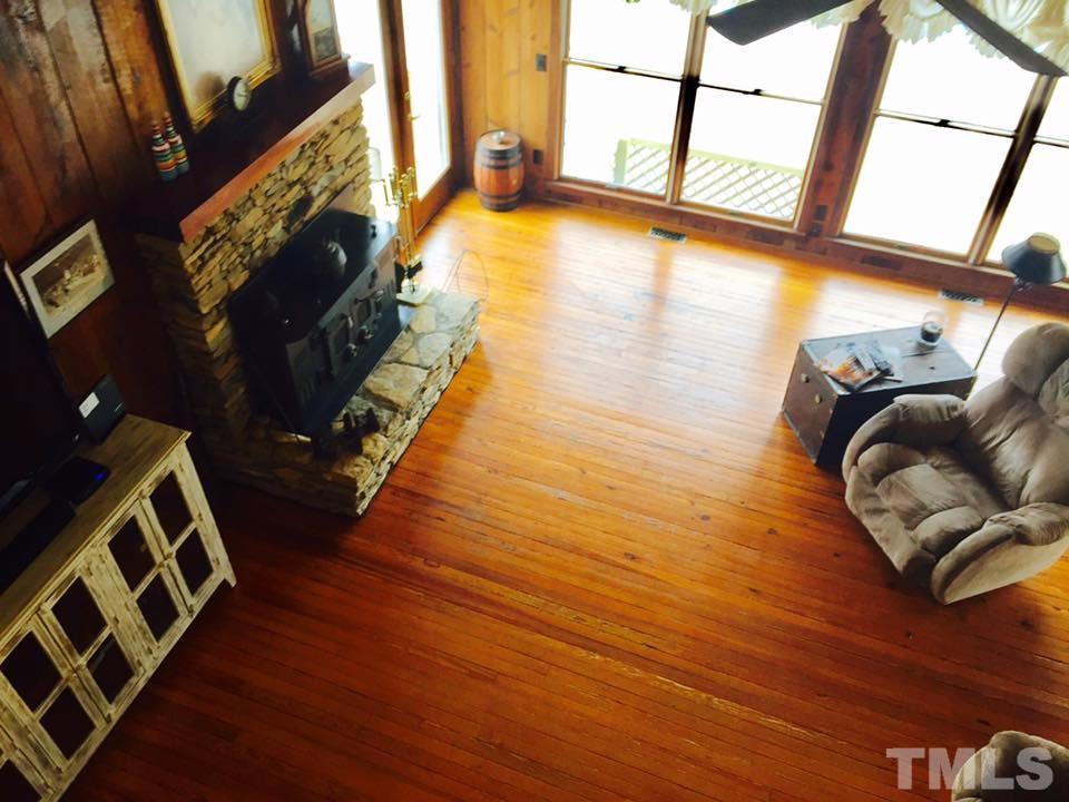 529 Noah Davis Road Roxboro, NC 27574 - Photo 9 of 25 a view of an empty room with wooden floor and a window