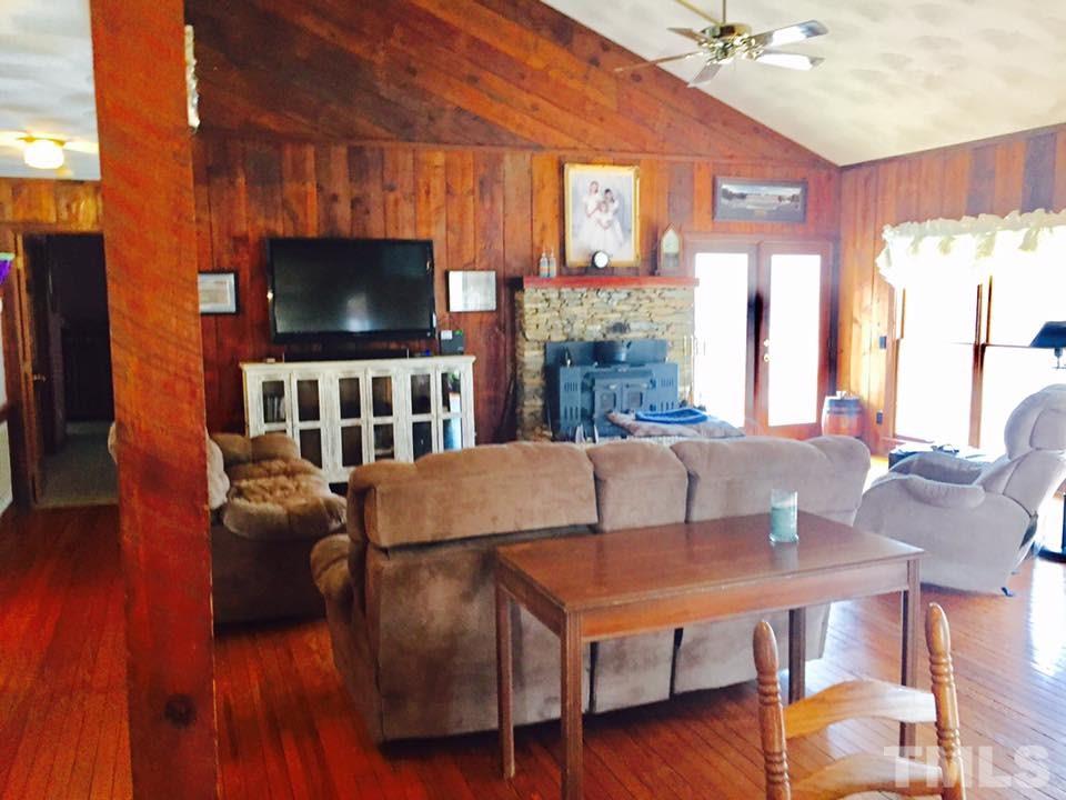 529 Noah Davis Road Roxboro, NC 27574 - Photo 10 of 25 a living room with furniture and a flat screen tv