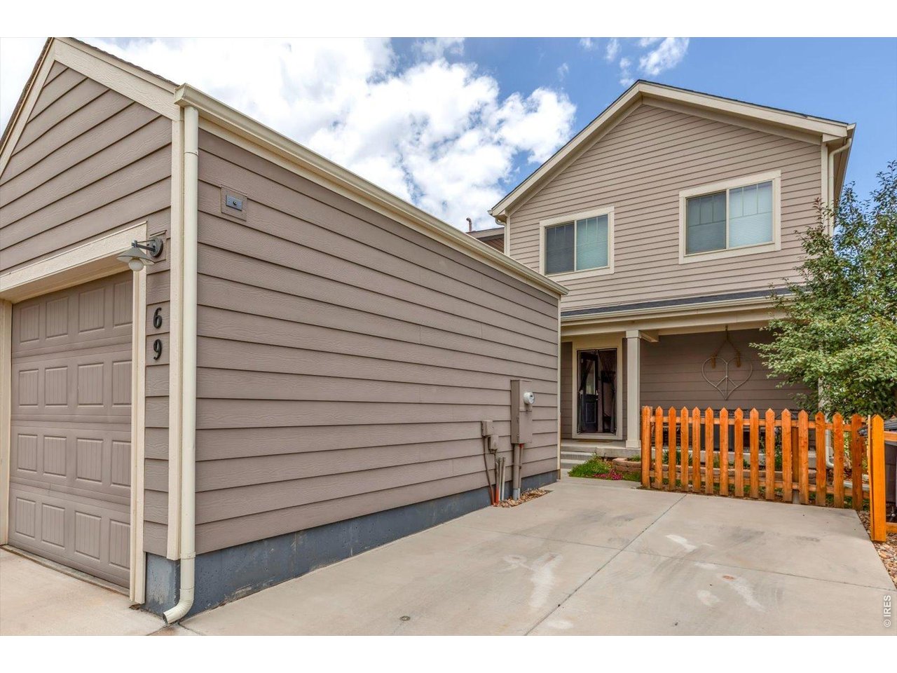 69 Quail Road Longmont, CO 80501 - Photo 22 of 25 Garage has a dedicated single car parking space right next to it. (Small fence/gate surround back patio).