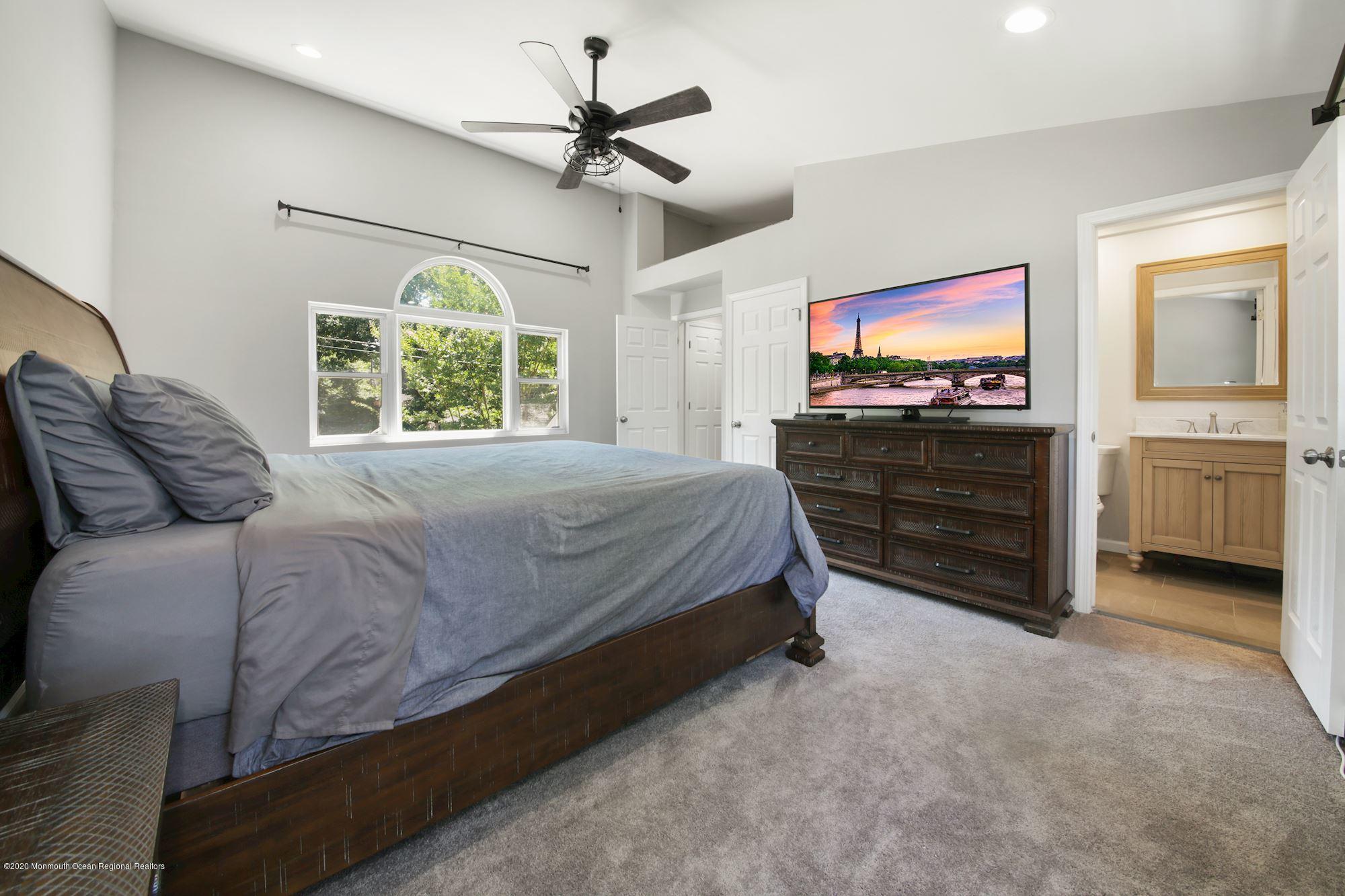8 Unity Drive Brick, NJ 08723 - Photo 14 of 22 a spacious bedroom with a bed and a flat screen tv