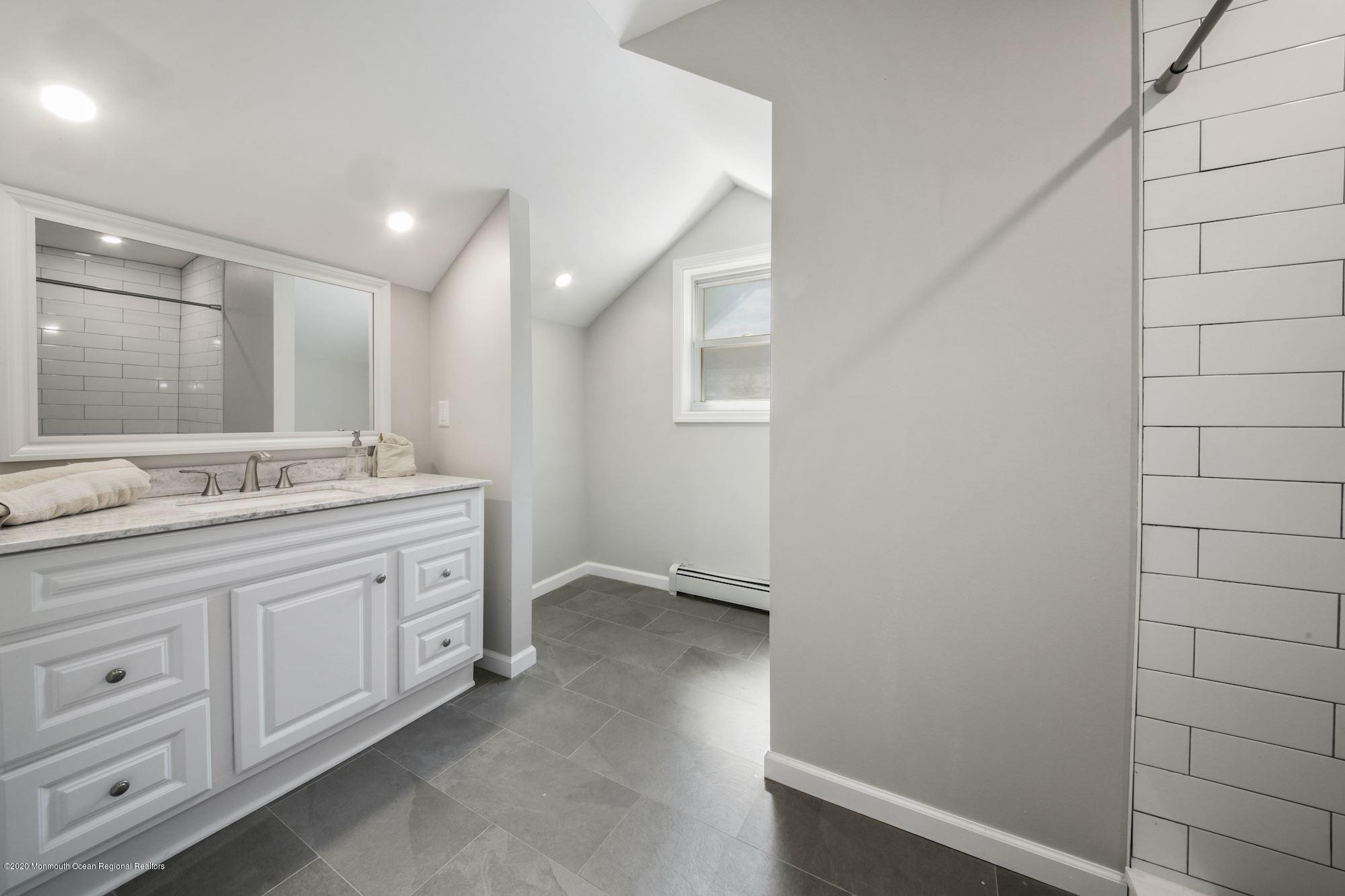 8 Unity Drive Brick, NJ 08723 - Photo 16 of 22 a bathroom with a granite countertop sink and a mirror