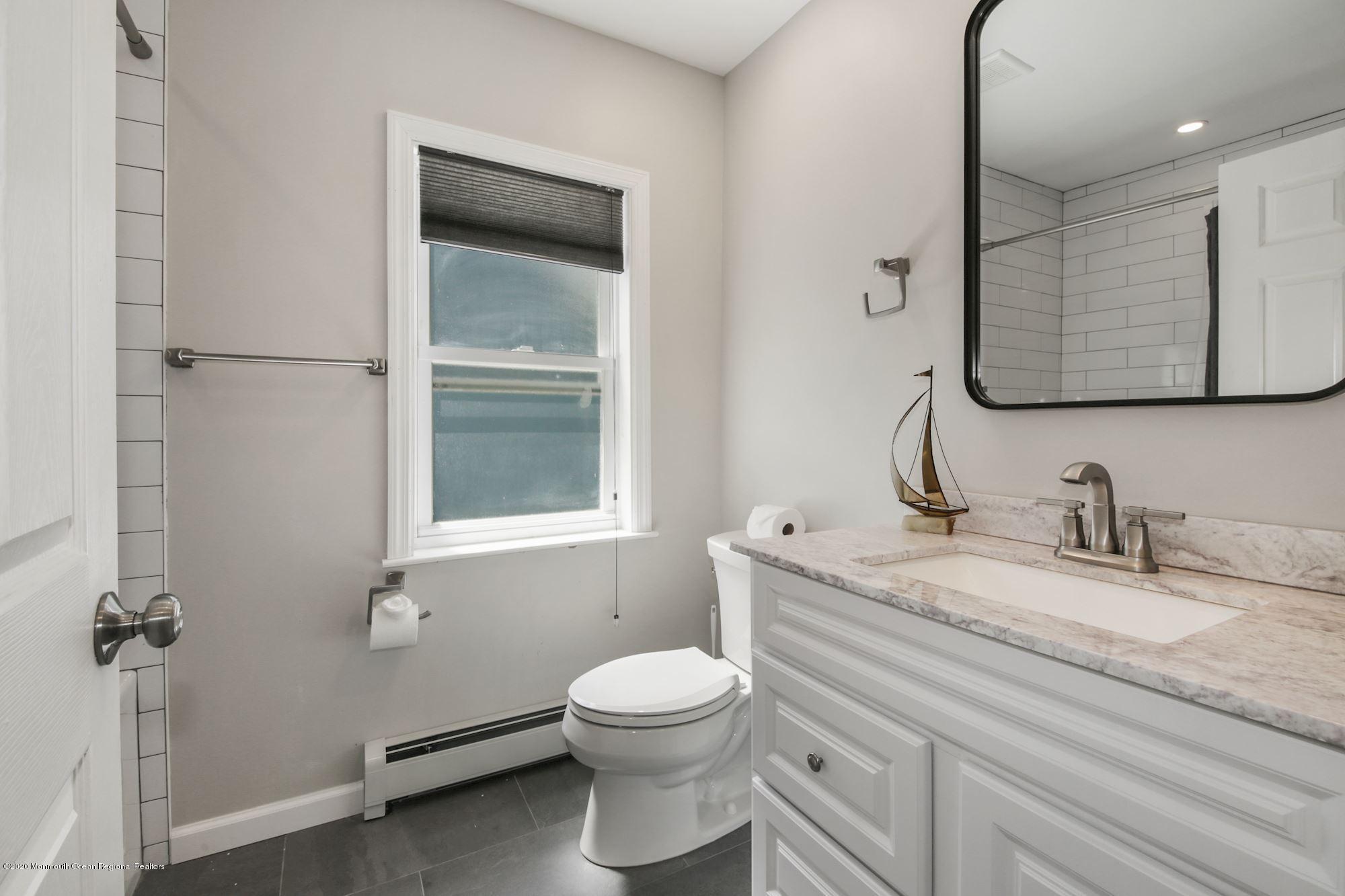 8 Unity Drive Brick, NJ 08723 - Photo 18 of 22 a bathroom with a granite countertop toilet sink and mirror