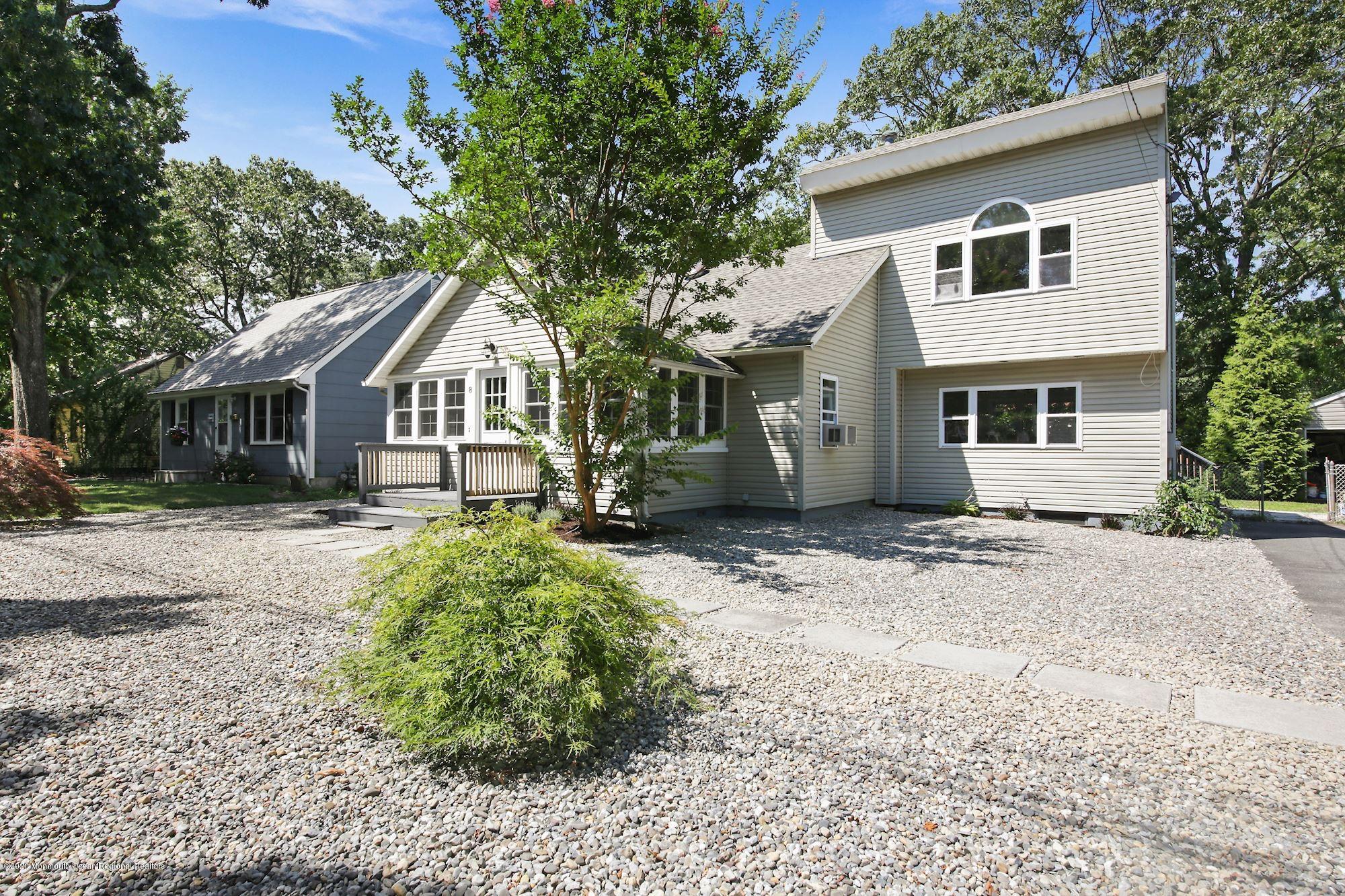 8 Unity Drive Brick, NJ 08723 - Photo 2 of 22 a front view of a house with a garden