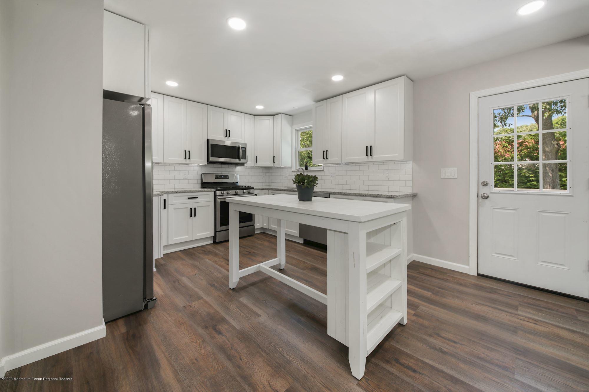 8 Unity Drive Brick, NJ 08723 - Photo 10 of 22 a kitchen with stainless steel appliances a stove a sink cabinets and wooden floor