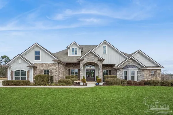 a front view of a house with a garden and porch