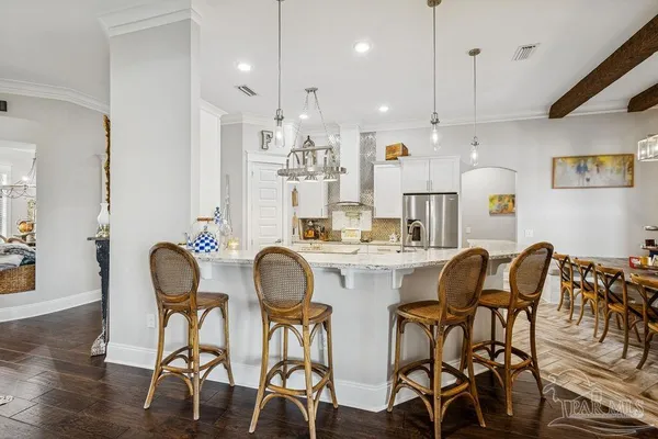 a kitchen with stainless steel appliances kitchen island granite countertop a refrigerator and a stove