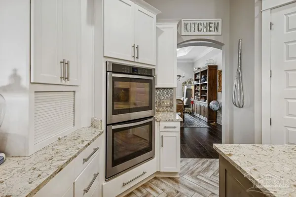 a view of a dining room with furniture a chandelier and wooden floor