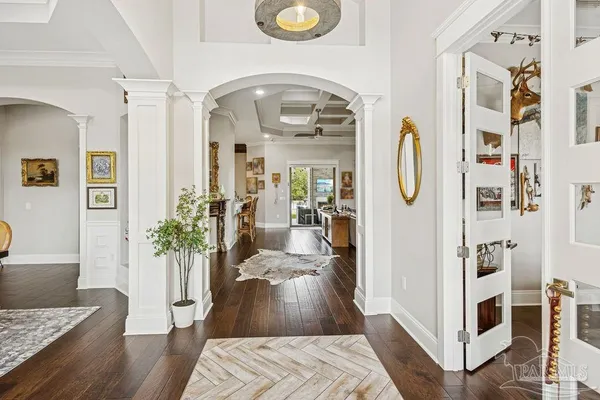 a living room with furniture and wooden floor