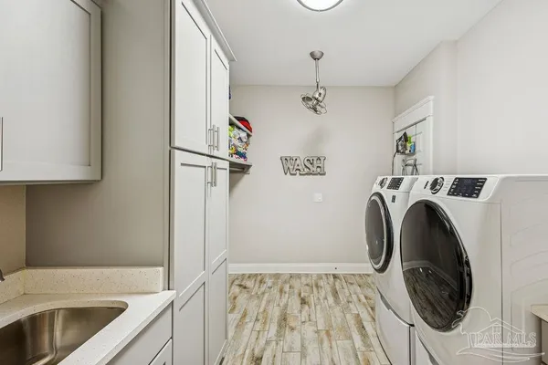 a bathroom with a sink a large mirror and a shower