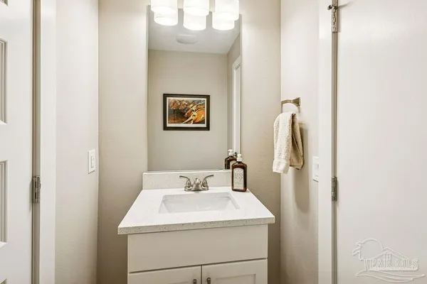 a bedroom with a bed a books bucket with a chair and a chandelier