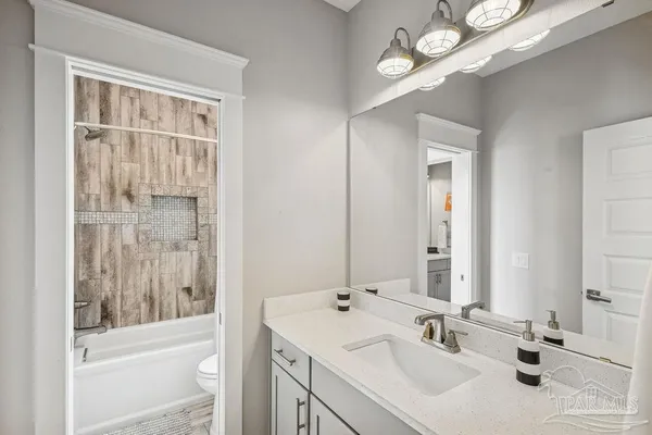 a backyard of a house with fountain table and chairs