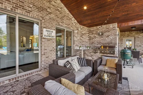 a view of a big house with a big yard plants and large trees