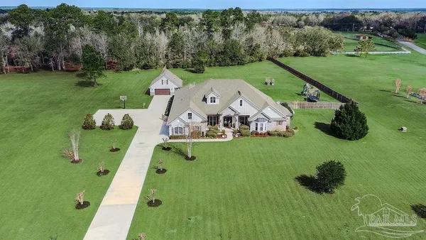 an aerial view of a house with garden space and street view