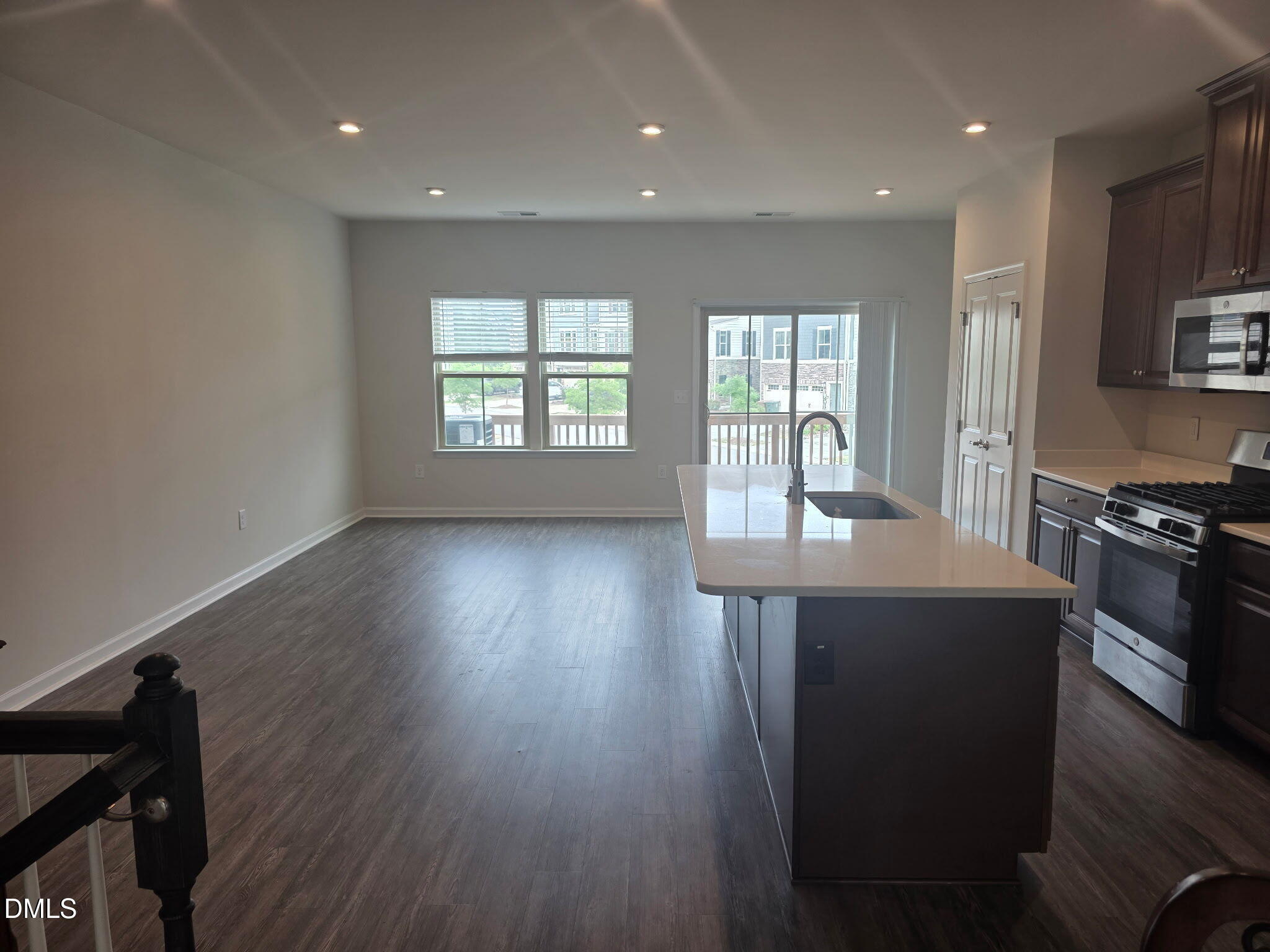 214 Timber Forest Lane Cary, NC 27519 - Photo 5 of 20 a kitchen with stainless steel appliances a dining table chairs stove refrigerator and wooden floor