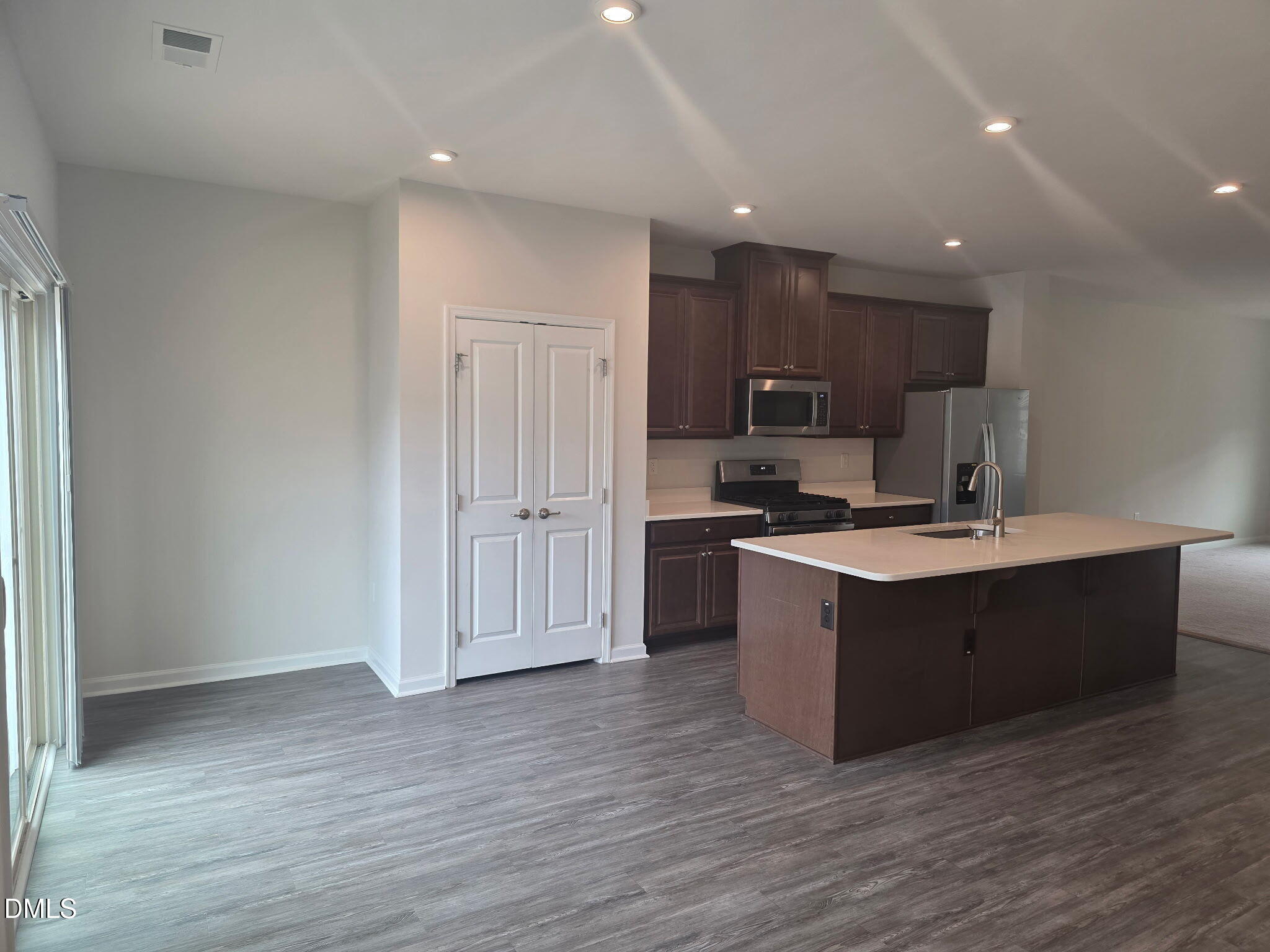 214 Timber Forest Lane Cary, NC 27519 - Photo 7 of 20 a kitchen with stainless steel appliances granite countertop a stove a sink and a refrigerator