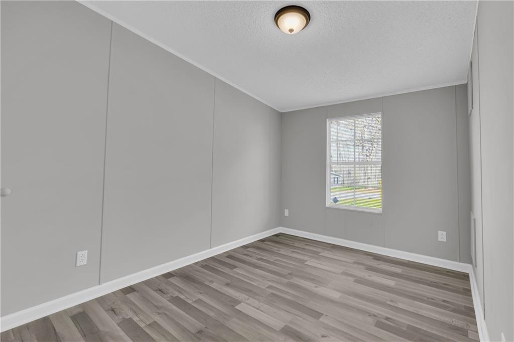 85 Winding Vine Lane Nicholson, GA 30565 - Photo 16 of 40 an empty room with wooden floor and windows