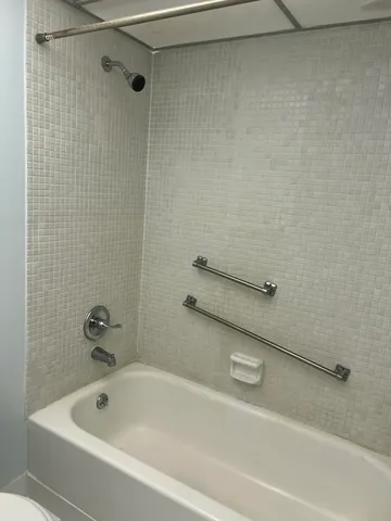 a bathroom with a tub and a shower