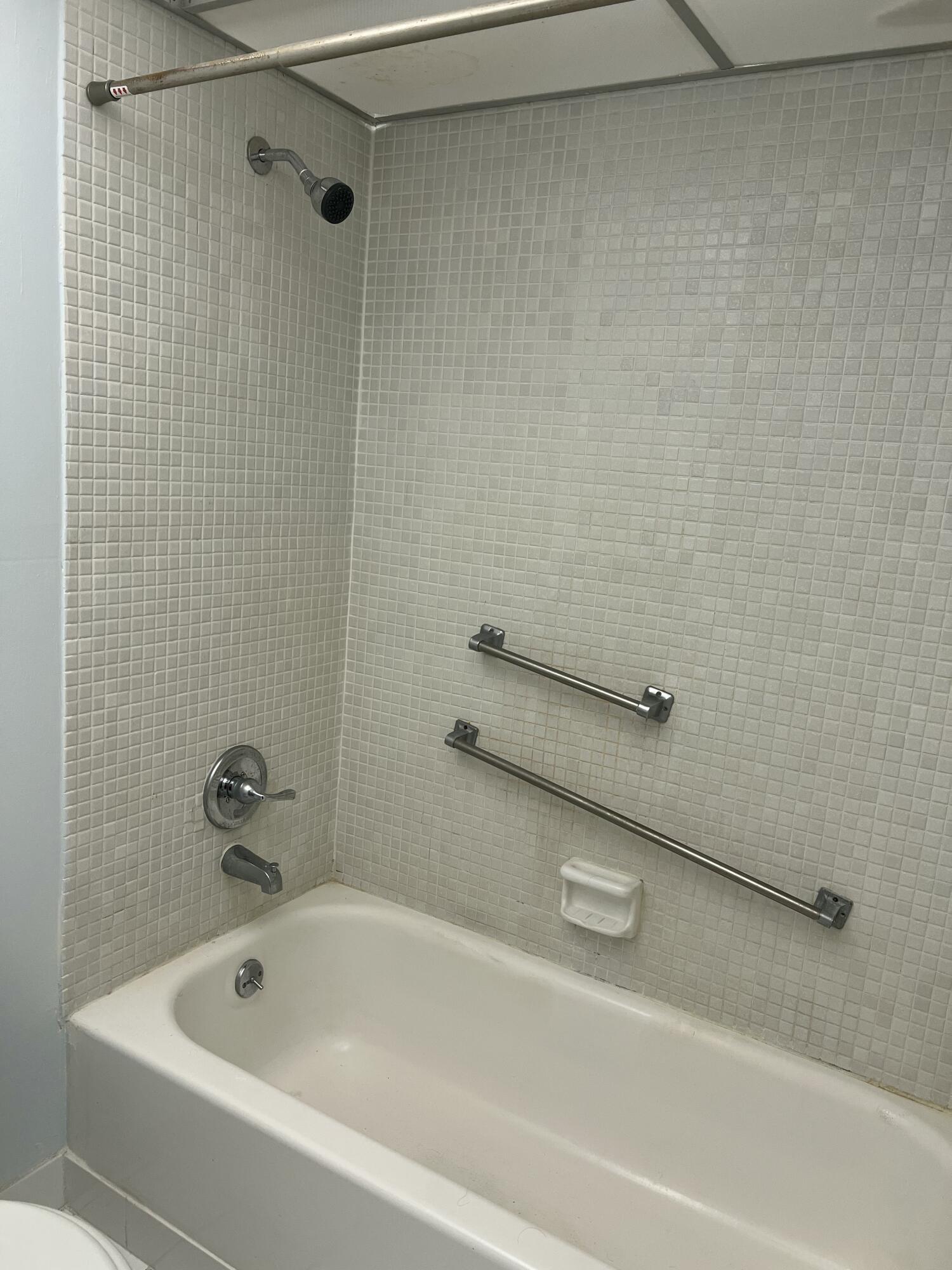 631 Brittany Lane Delray Beach, FL 33446 - Photo 7 of 11 a bathroom with a tub and a shower