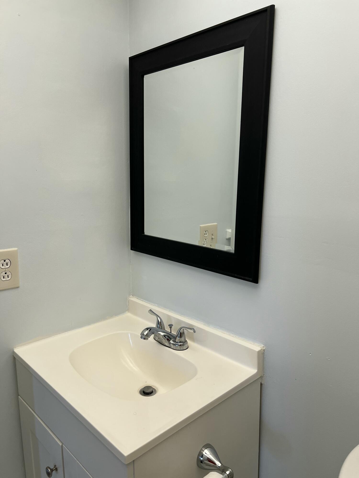 631 Brittany Lane Delray Beach, FL 33446 - Photo 8 of 11 a bathroom with a sink and a mirror