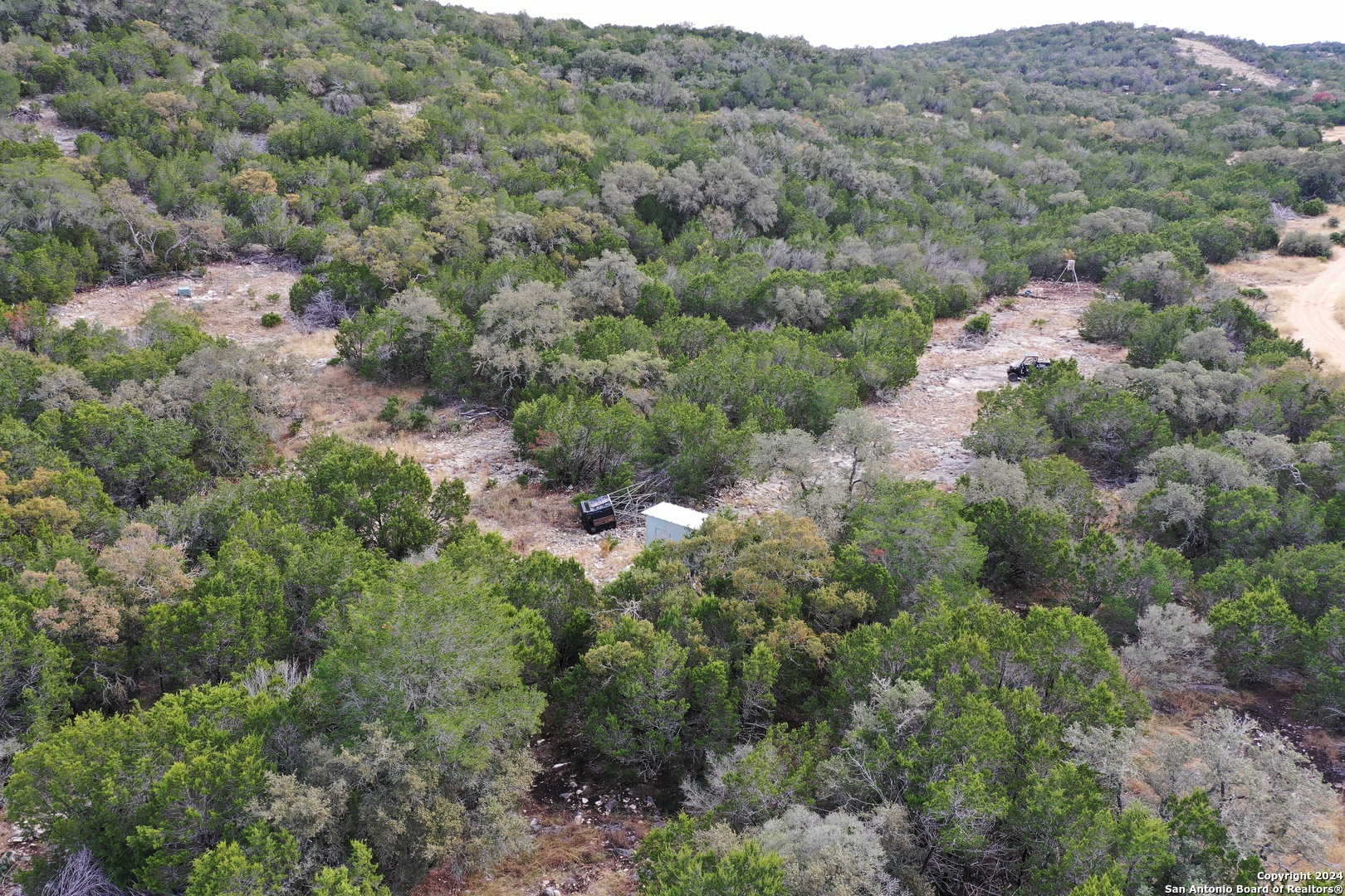 1048 Sd 46067 Del Rio, TX 78840 - Photo 18 of 23 an aerial view of a house with a lush green forest