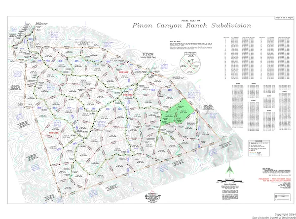 a view of a dry yard with wooden fence