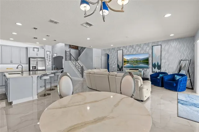 a room with bed furniture and a large window