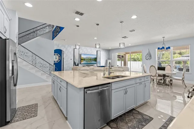 a kitchen with sink stove and cabinets