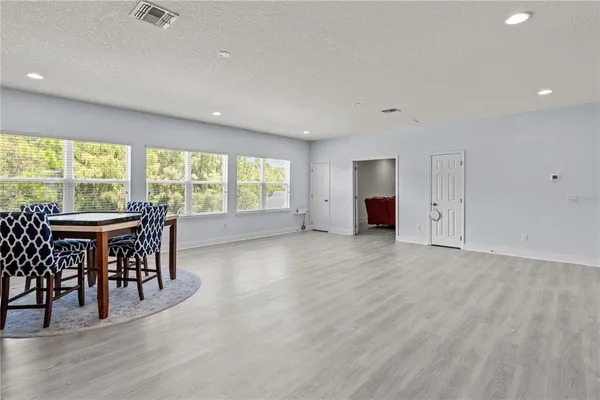 an empty room with furniture and a large window
