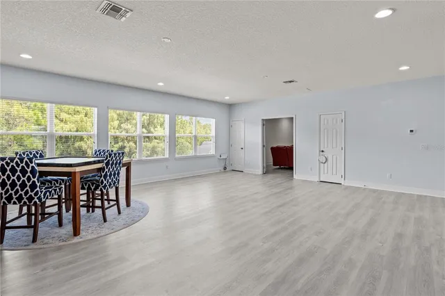 an empty room with furniture and a large window