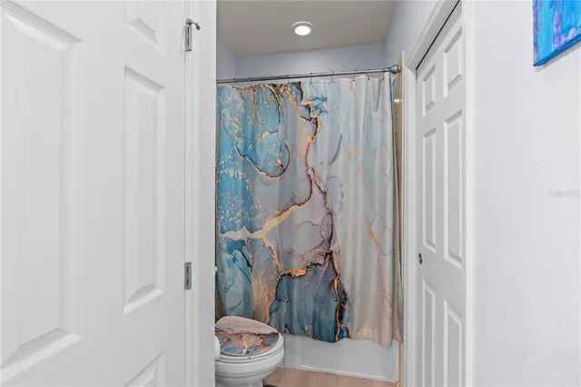 a bathroom with a shower toilet and sink
