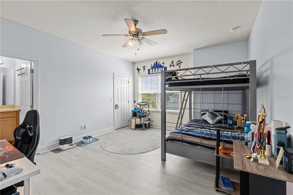 a bedroom with furniture and gym equipment