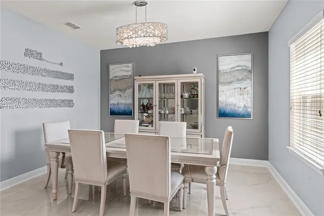 a view of a dining room with furniture wooden floor and chandelier
