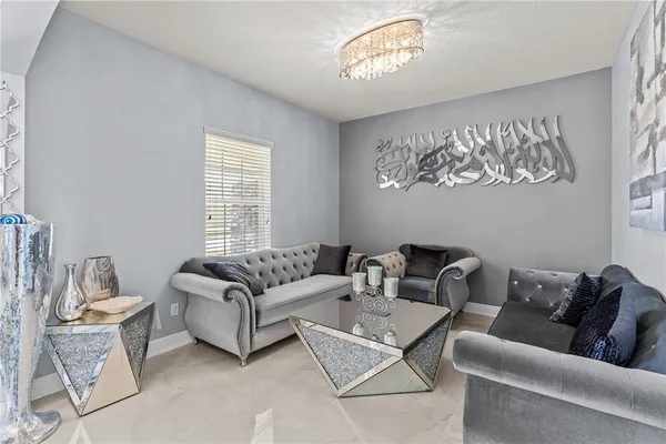 a living room with furniture a couch and a window