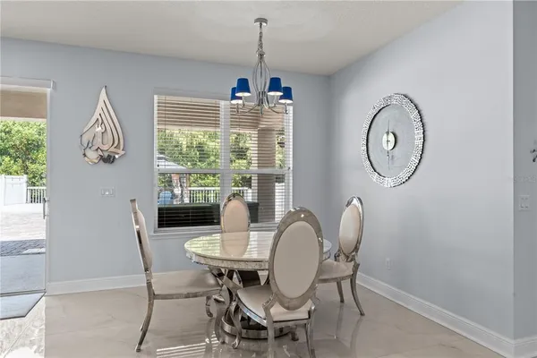 a dining room with furniture a window and a chandelier