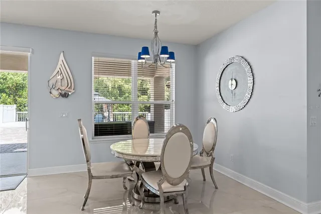 a dining room with furniture a window and a chandelier