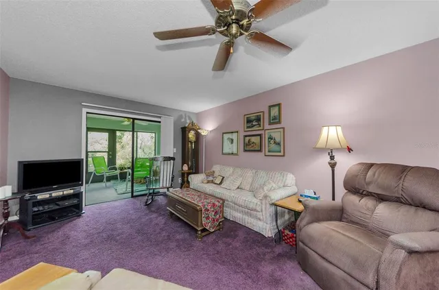 a living room with patio furniture and a window