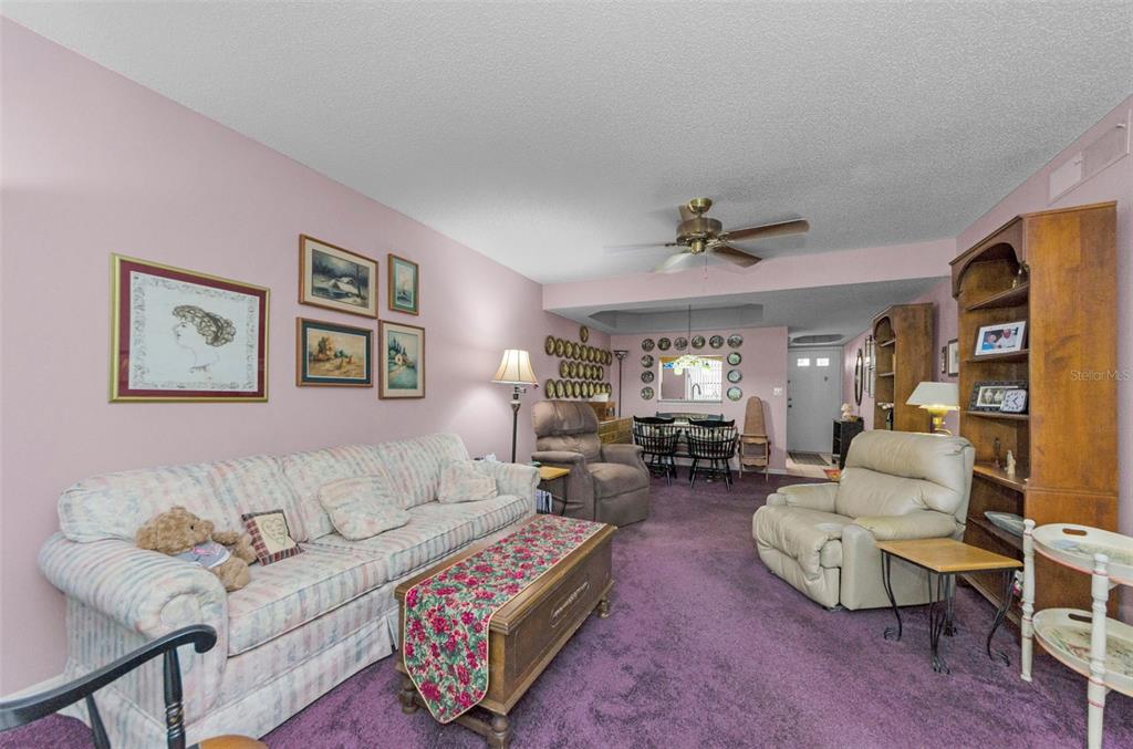 2119 Elm Street, Unit 103 Dunedin, FL 34698 - Photo 13 of 69 a living room with furniture and a large window